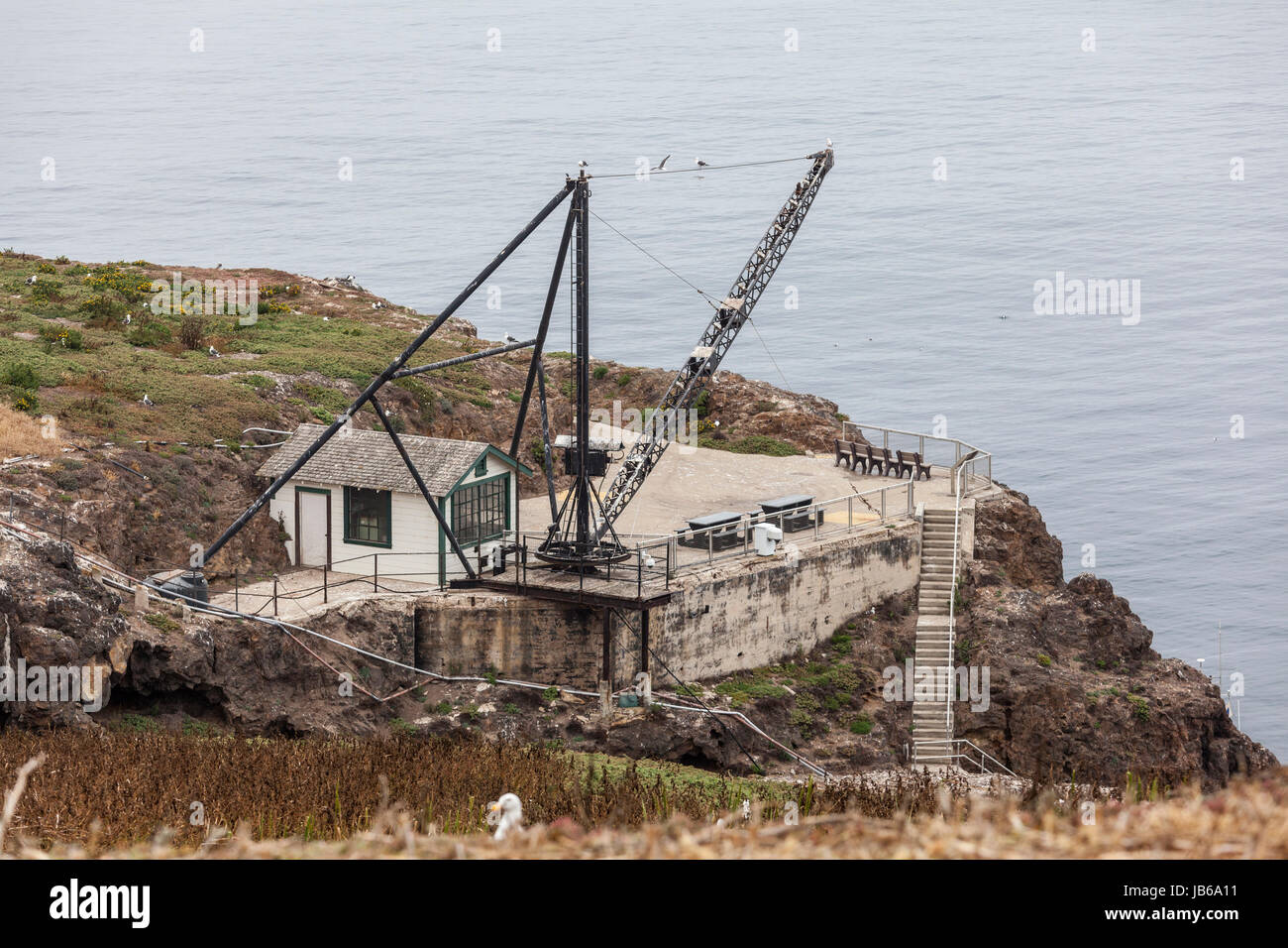 Old crane and support building at Anacapa Island in Channel Islands National Park in Southern California. Stock Photo