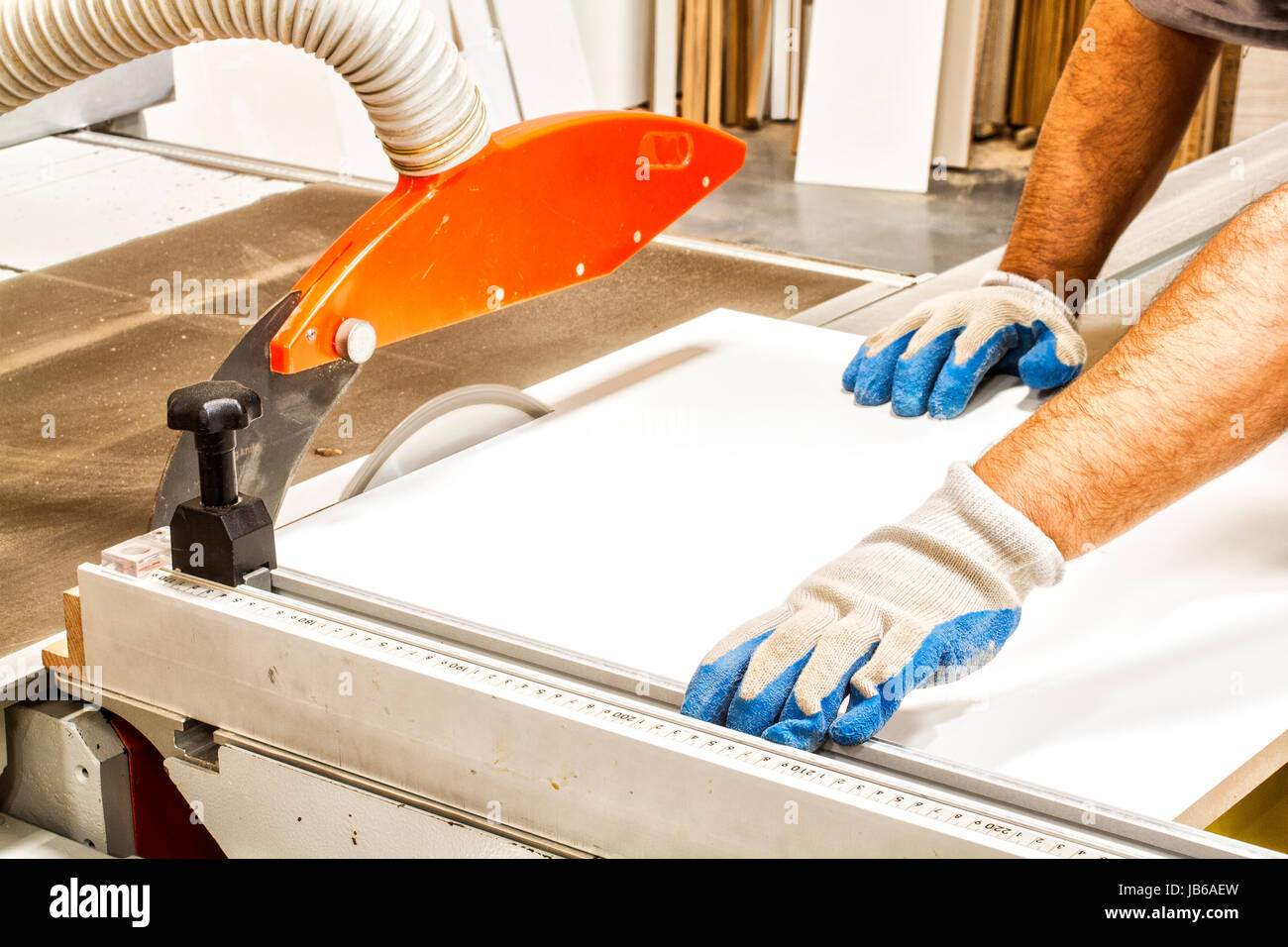 Hands of a joiner working with a circular saw in a joinery. Palhoca