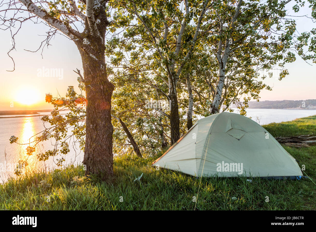 Sunrise over the river. Tourist tent. River bank Stock Photo - Alamy