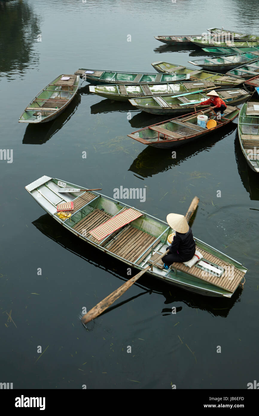 Woman in boat at Ninh Hai boat harbour for Tam Coc boat trips, Ninh Binh, Vietnam Stock Photo