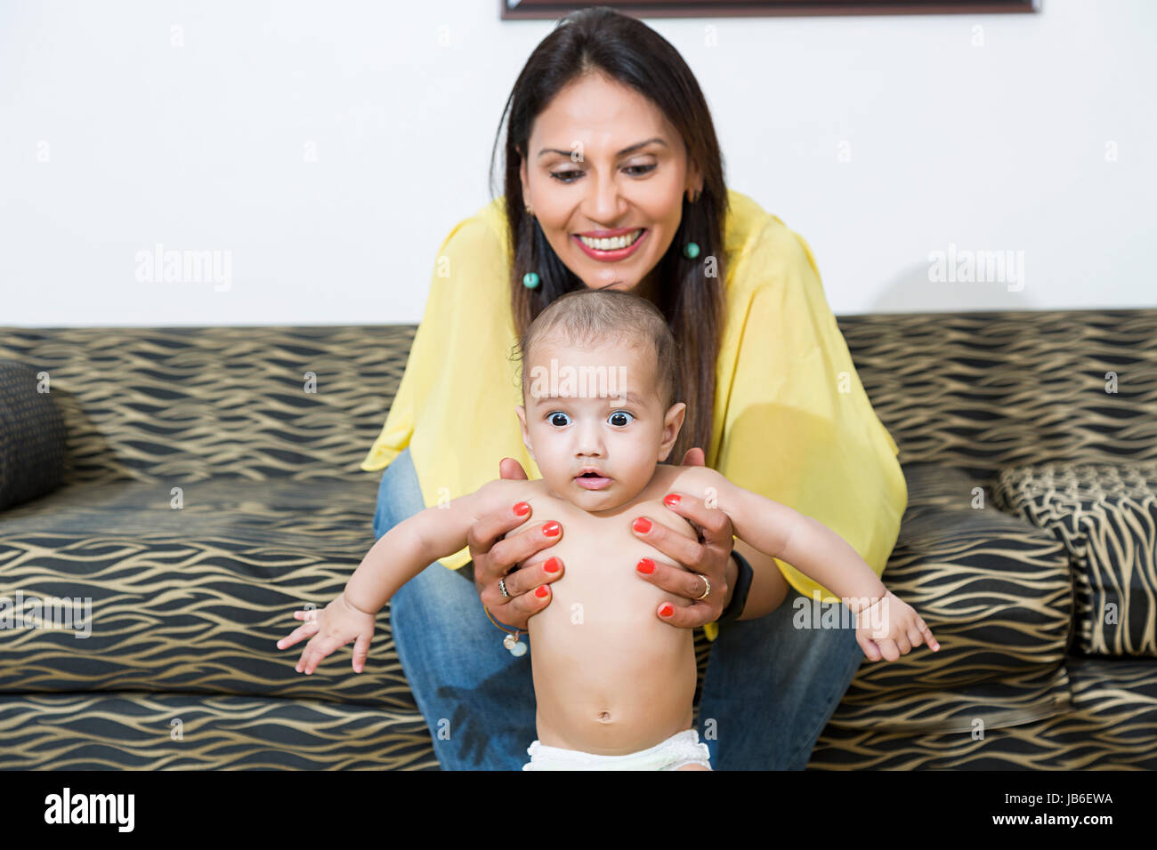 2 People Adult Woman At Home Baby Beginning Boy Helping Holding Smiling Standing Stock Photo