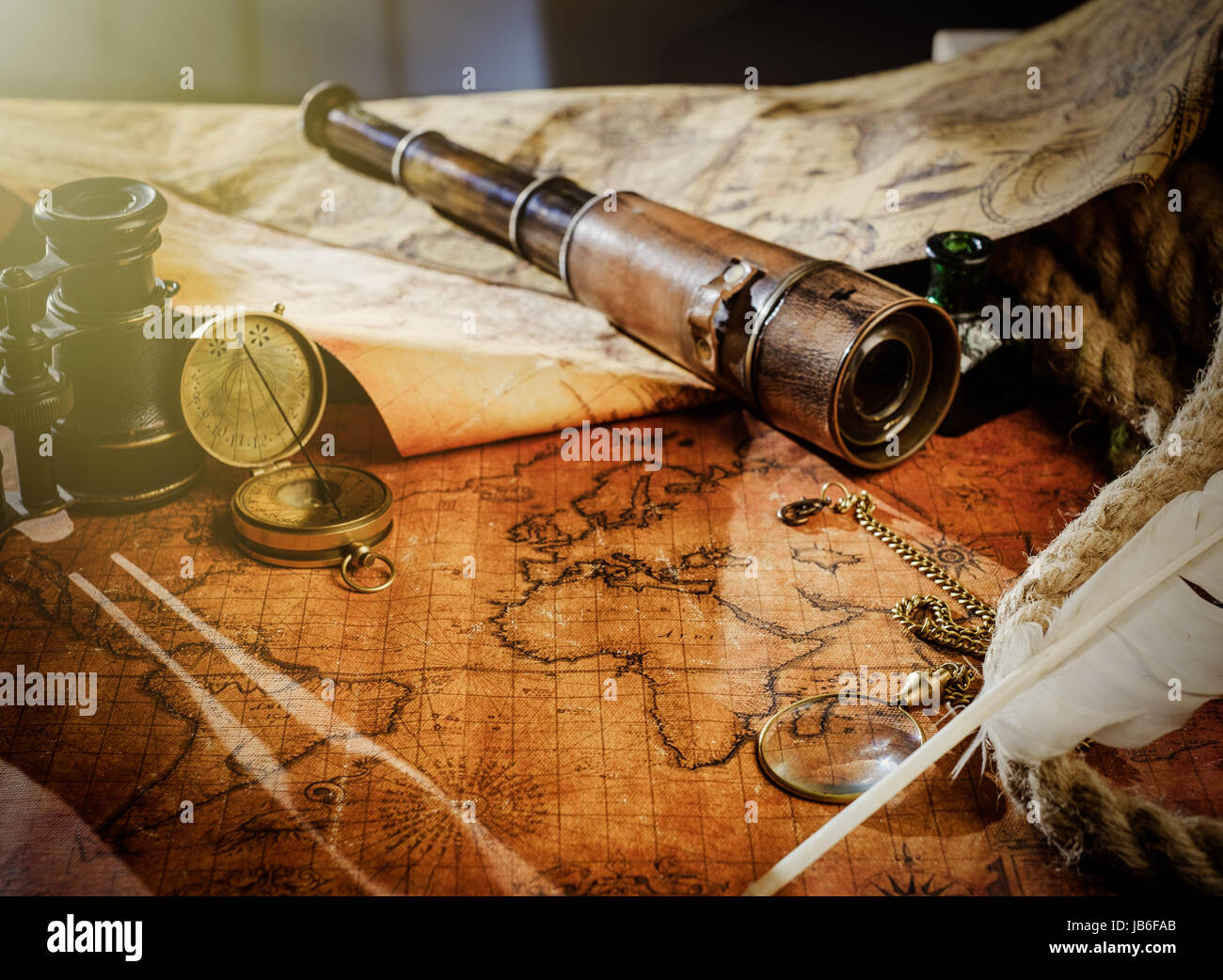 Old vintage retro compass and spyglass on ancient world map. Vintage ...