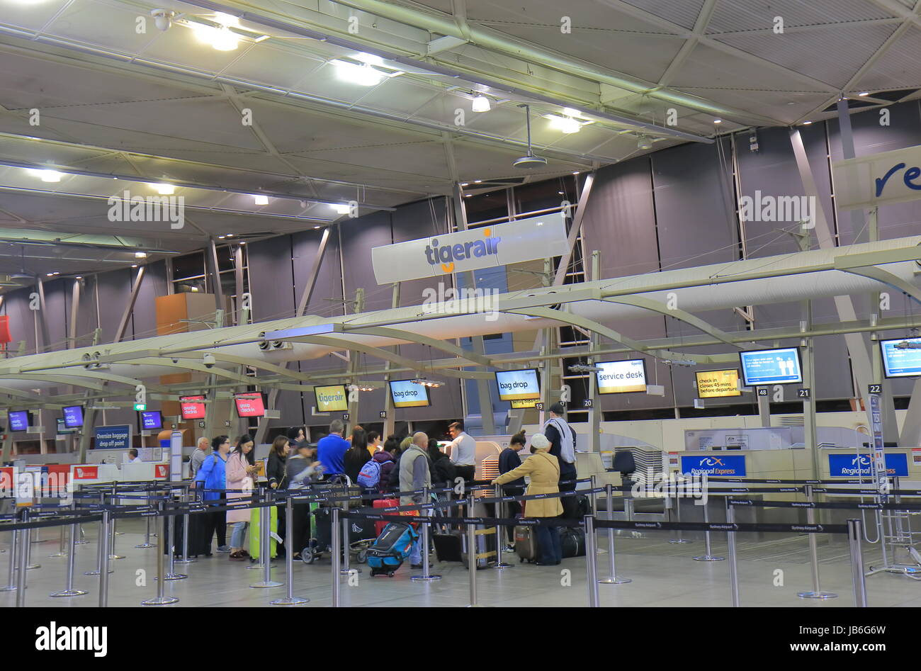 People check in at Tigerair counter Sydney Airport in Sydney Australia. Stock Photo