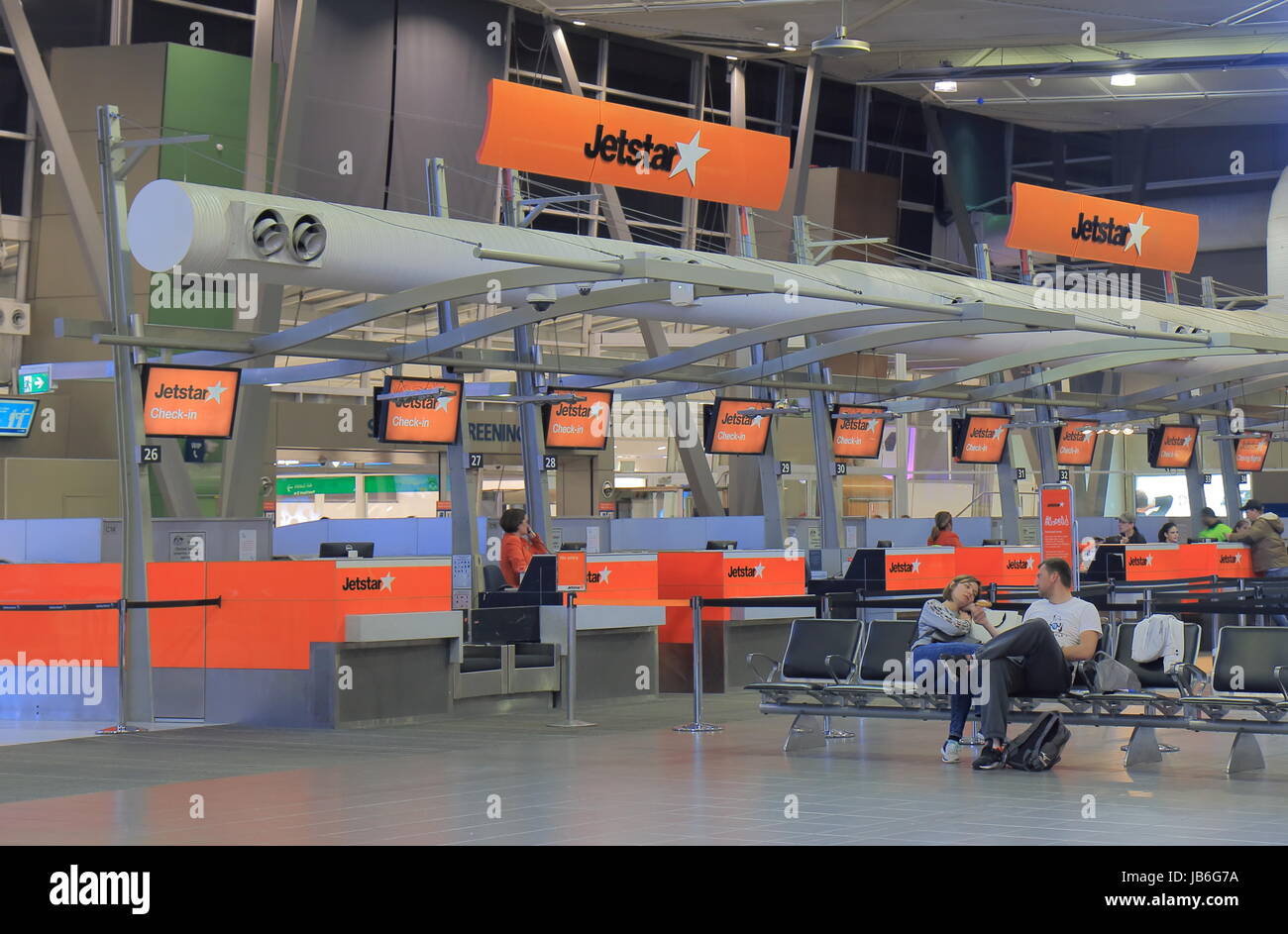 People wait at Jetstar check in counter Sydney Airport in Sydney Australia. Stock Photo
