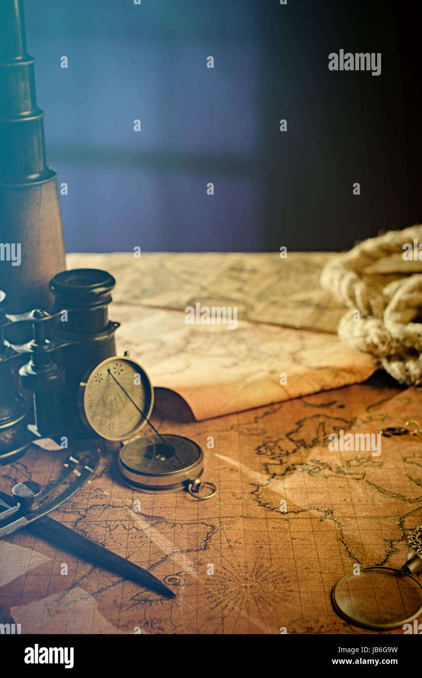 Old vintage retro compass and spyglass on ancient world map. Vintage ...