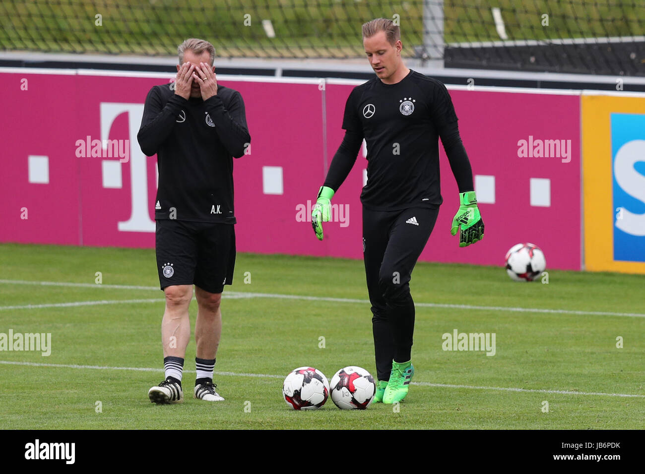 Germany goalie Marc-Andre ter Stegen (r) and goalkeeping coach Andreas Koepke during a training session ahead of the 10 June World Cup qualifier against San Marino, in Herzogenaurach, Germany, 9 June 2017. Photo: Daniel Karmann/dpa Stock Photo