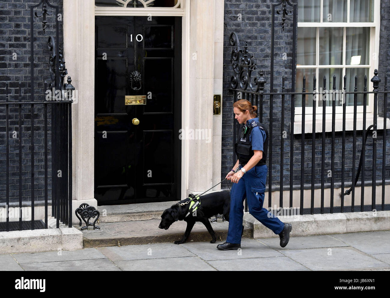Police patrolling at Number 10 Downing Street, London, UK. Security at Downing St Stock Photo