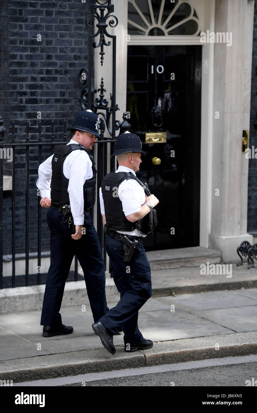 Police patrolling at Number 10 Downing Street, London, UK. Security at Downing St Stock Photo
