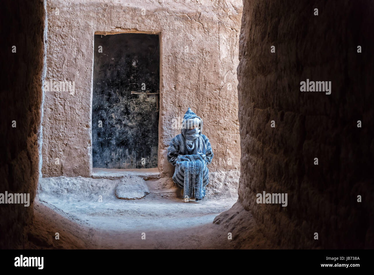 A traditional dressed Moroccan man inside a Kasbah. Stock Photo