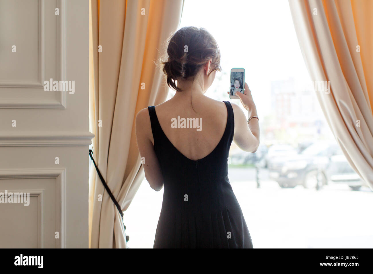 Woman blogger doing selfie at window Stock Photo