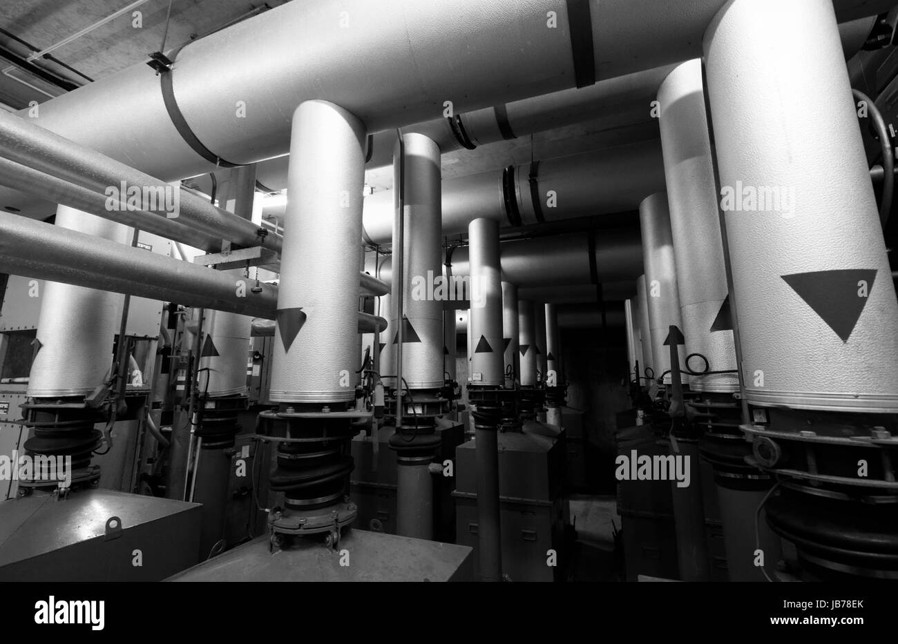 Metal pipework part of air pumping and filtration system in an underground bunker. Stock Photo