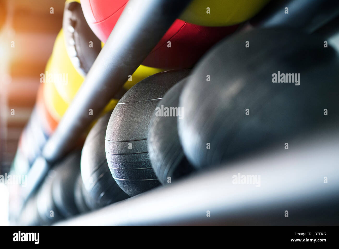 Medicine balls on shelf in modern gym. Stock Photo
