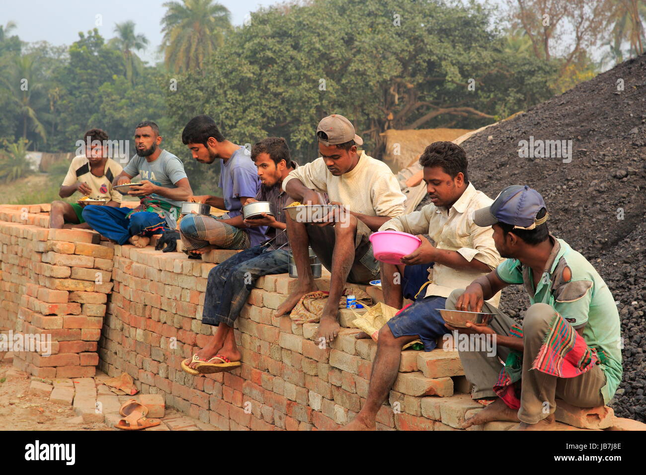 Brickfield workers taking meal. Khulna, Bangladesh Stock Photo