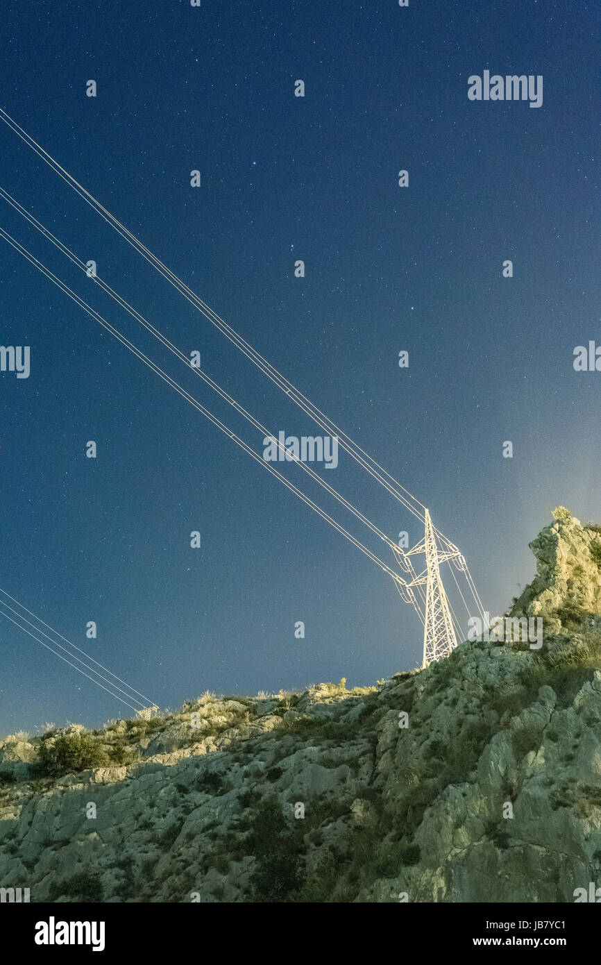 Power lines and tower under a starry night sky Stock Photo - Alamy