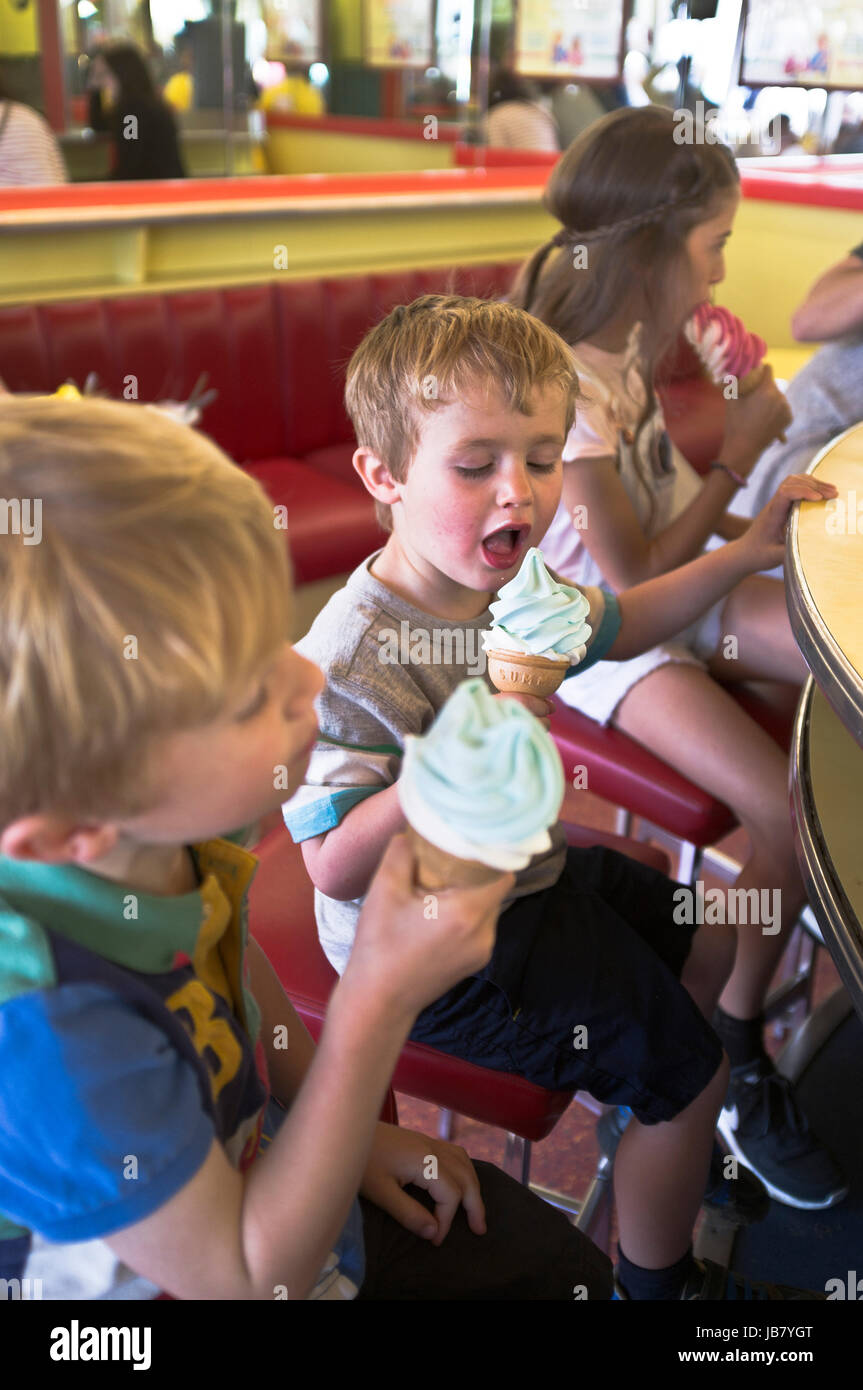 dh BOY CHILDREN children eating icecream cone boy licking ice cream Scarborough cafe Stock Photo