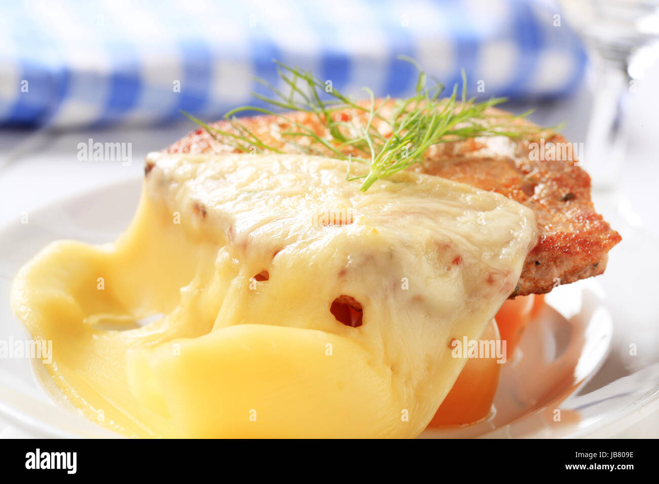 Marinated pork chop topped with slices of Swiss cheese Stock Photo Alamy