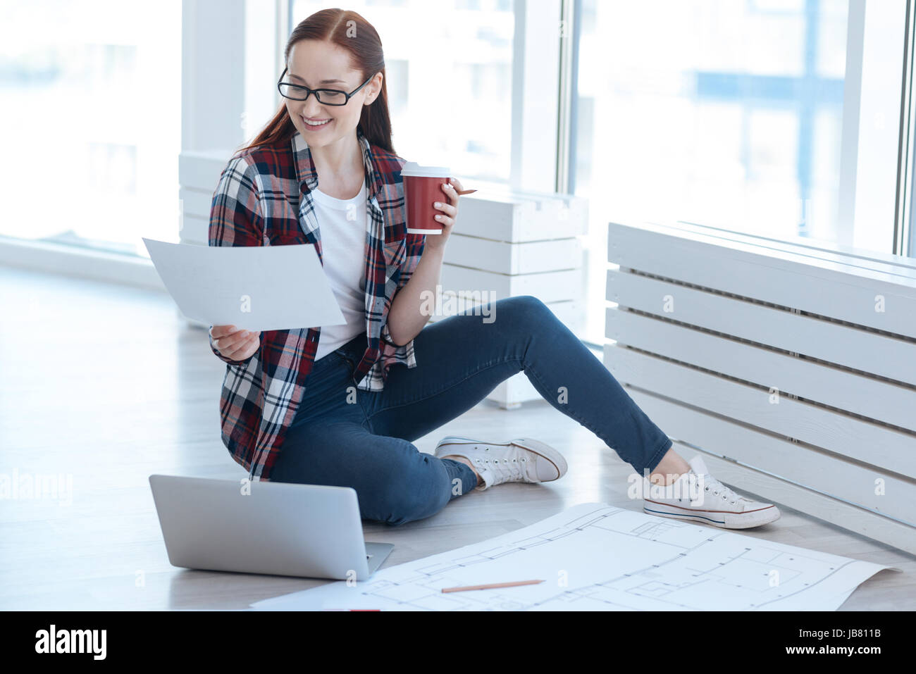 Positive delighted woman looking at the drawing Stock Photo - Alamy