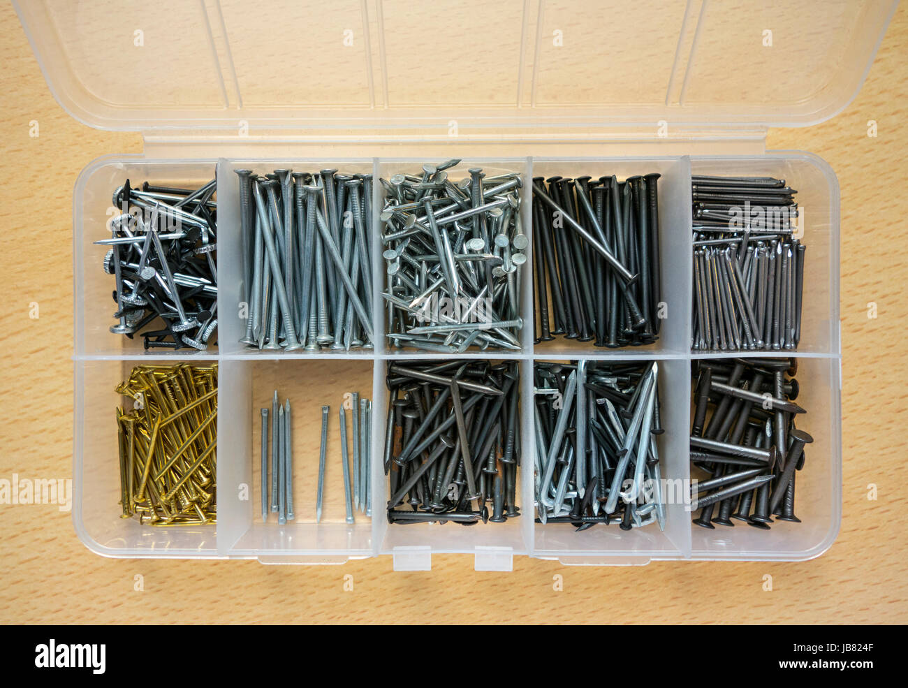 A handyman's box of assorted picture-hanging pins and nails Stock Photo