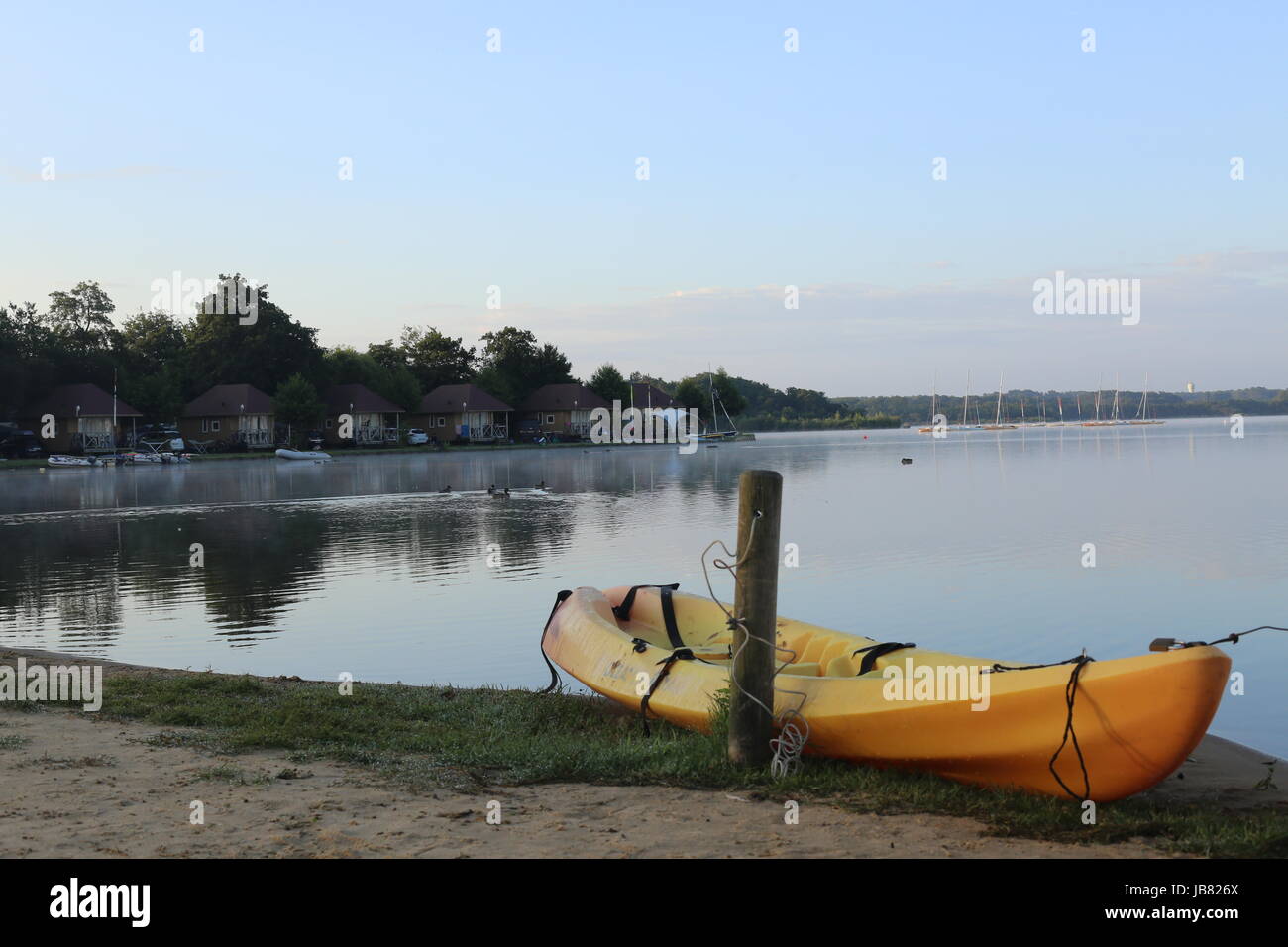 Clear and tranquil lake with reflections of clear sky Stock Photo - Alamy