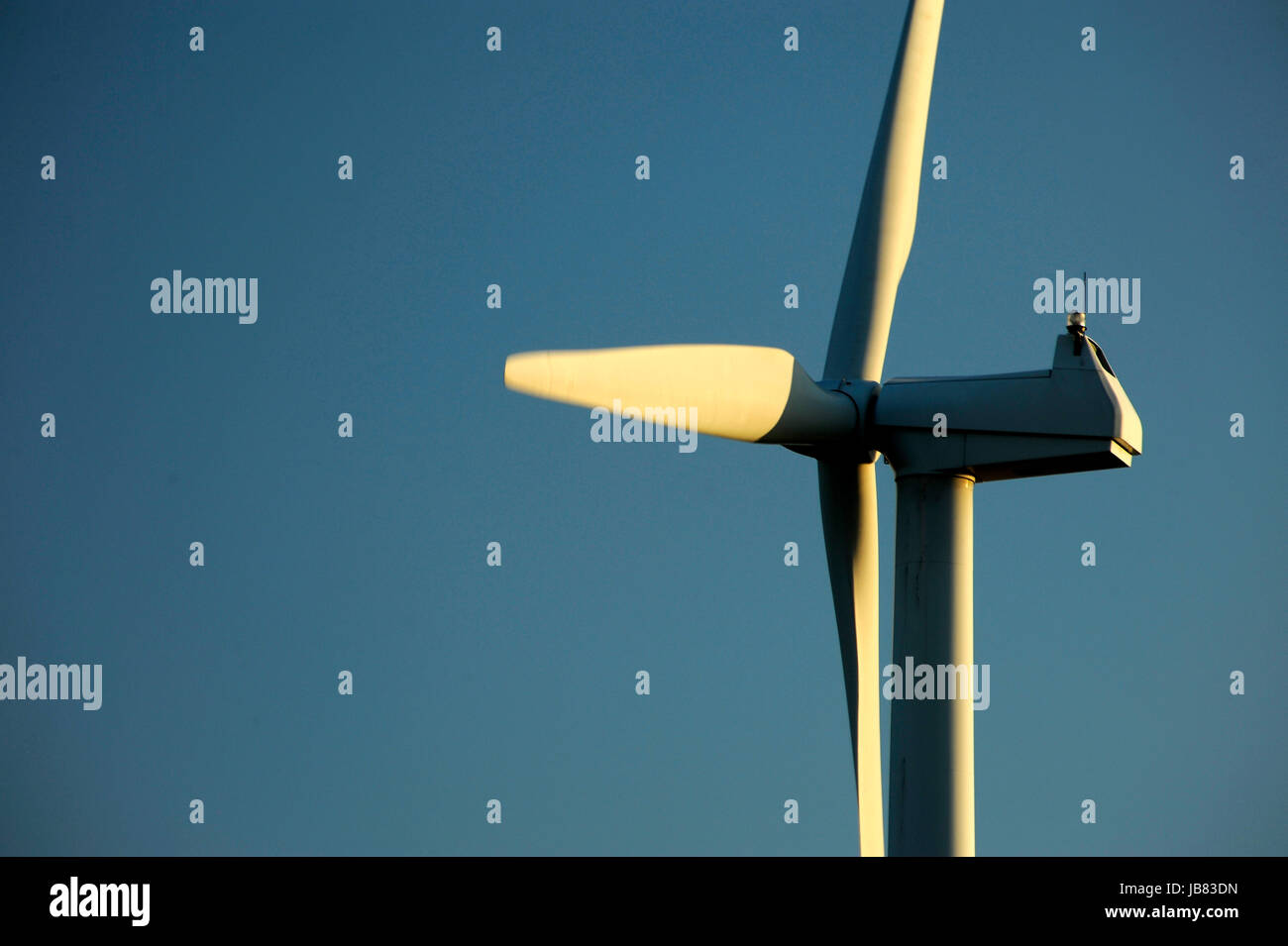 Wind turbine set against a clear blue winter sky Stock Photo - Alamy