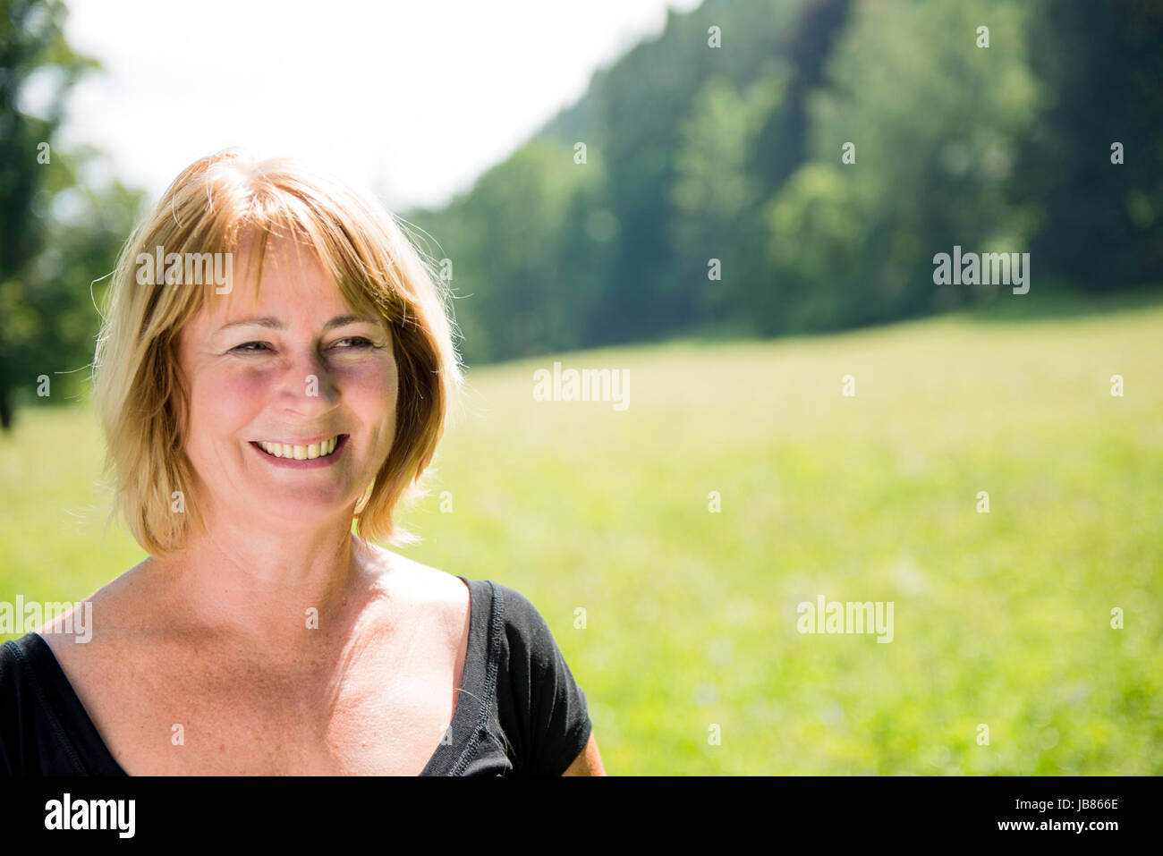 Portrait of happy smiling mature woman - outdoor in nature Stock Photo ...