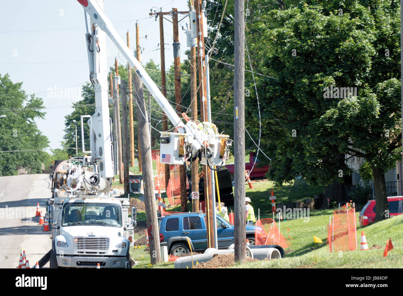 Electrical Lineman In Bucket Truck Installing New Lines Stock Photo