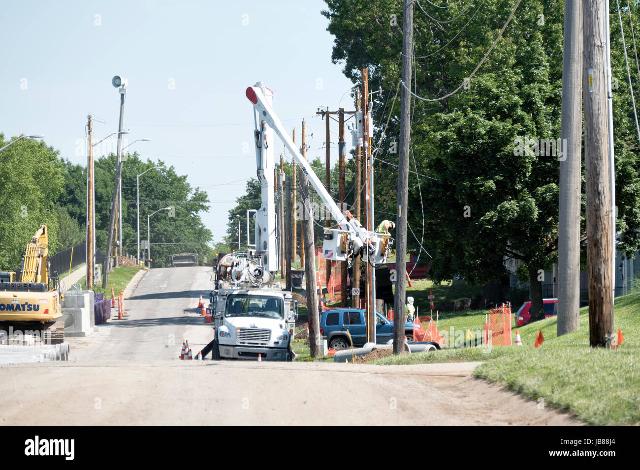 Electrical Lineman In Bucket Truck Installing New Lines Stock Photo