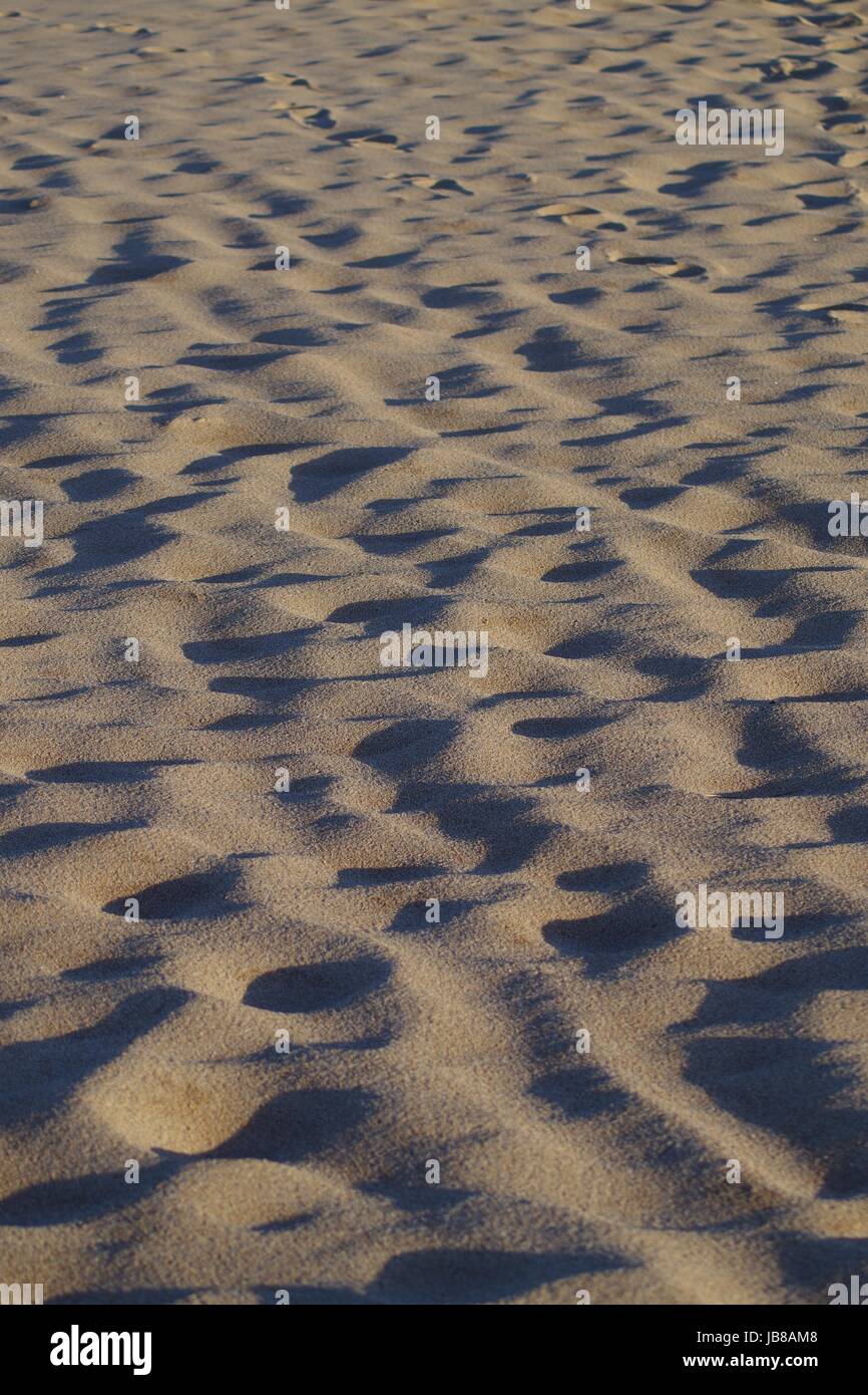 Textured Beach Sand and Footprints in the Evening Golden Light, Aberdeen Beach, April 2017, Scotland. Stock Photo