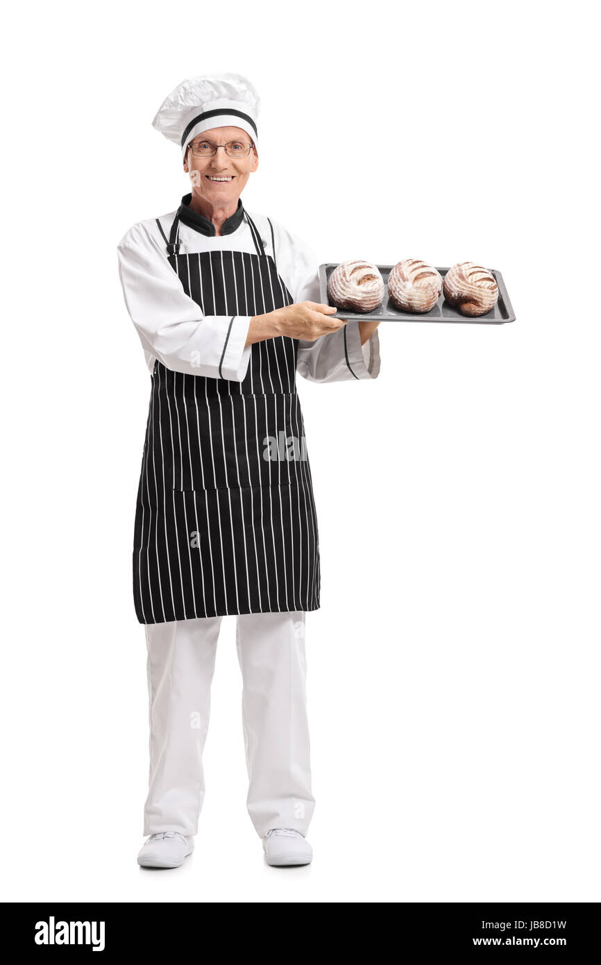 Full length portrait of a baker holding a tray with loaves of bread isolated on white background Stock Photo
