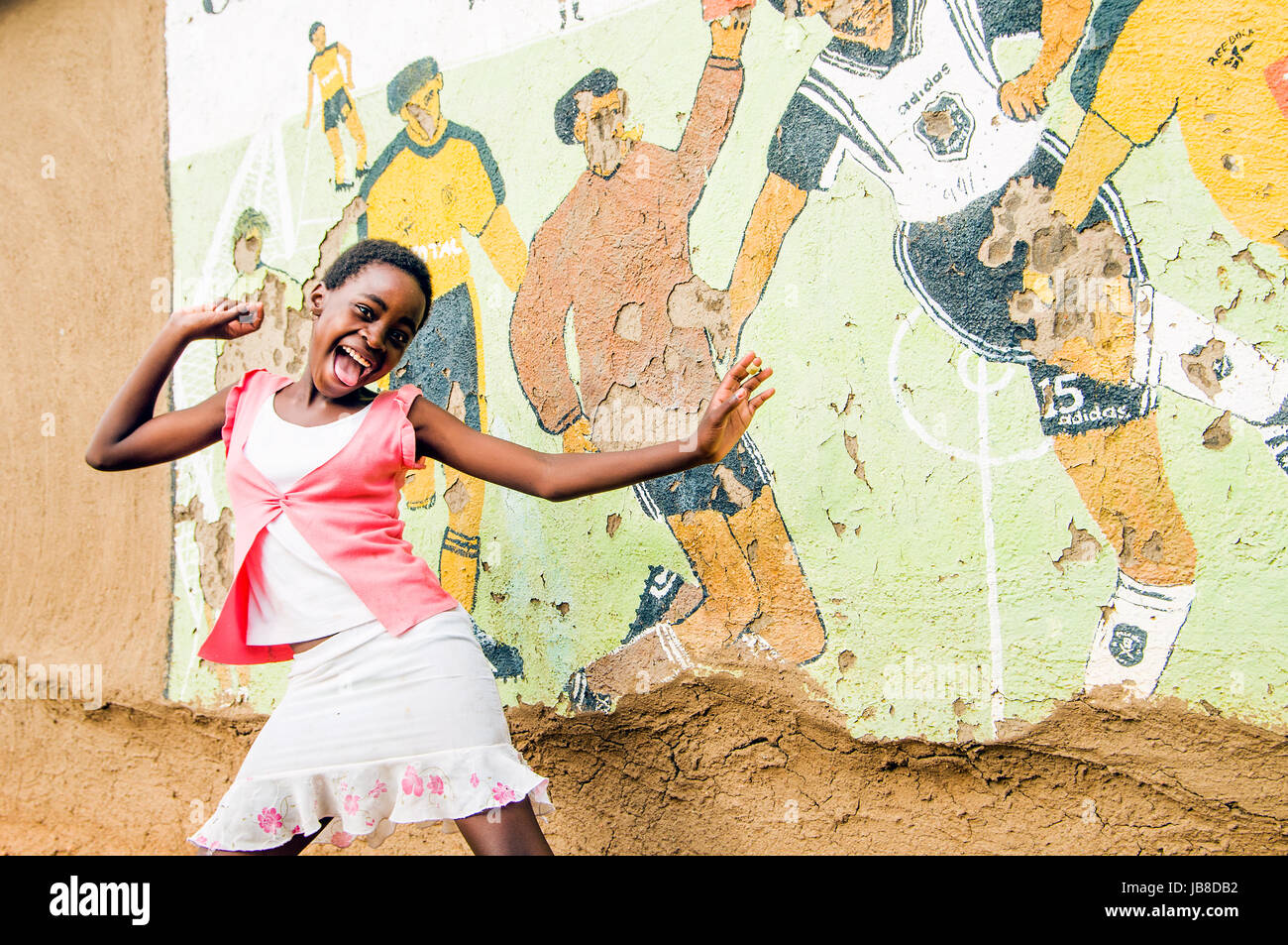 Girl in front of football street art, Olifants River, South Africa Stock Photo