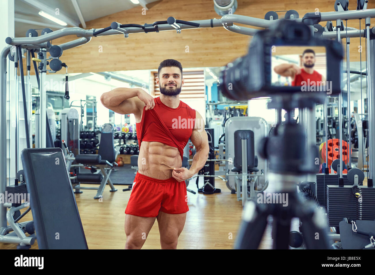 Vlogger athlete bodybuilder makes a video in the gym Stock Photo