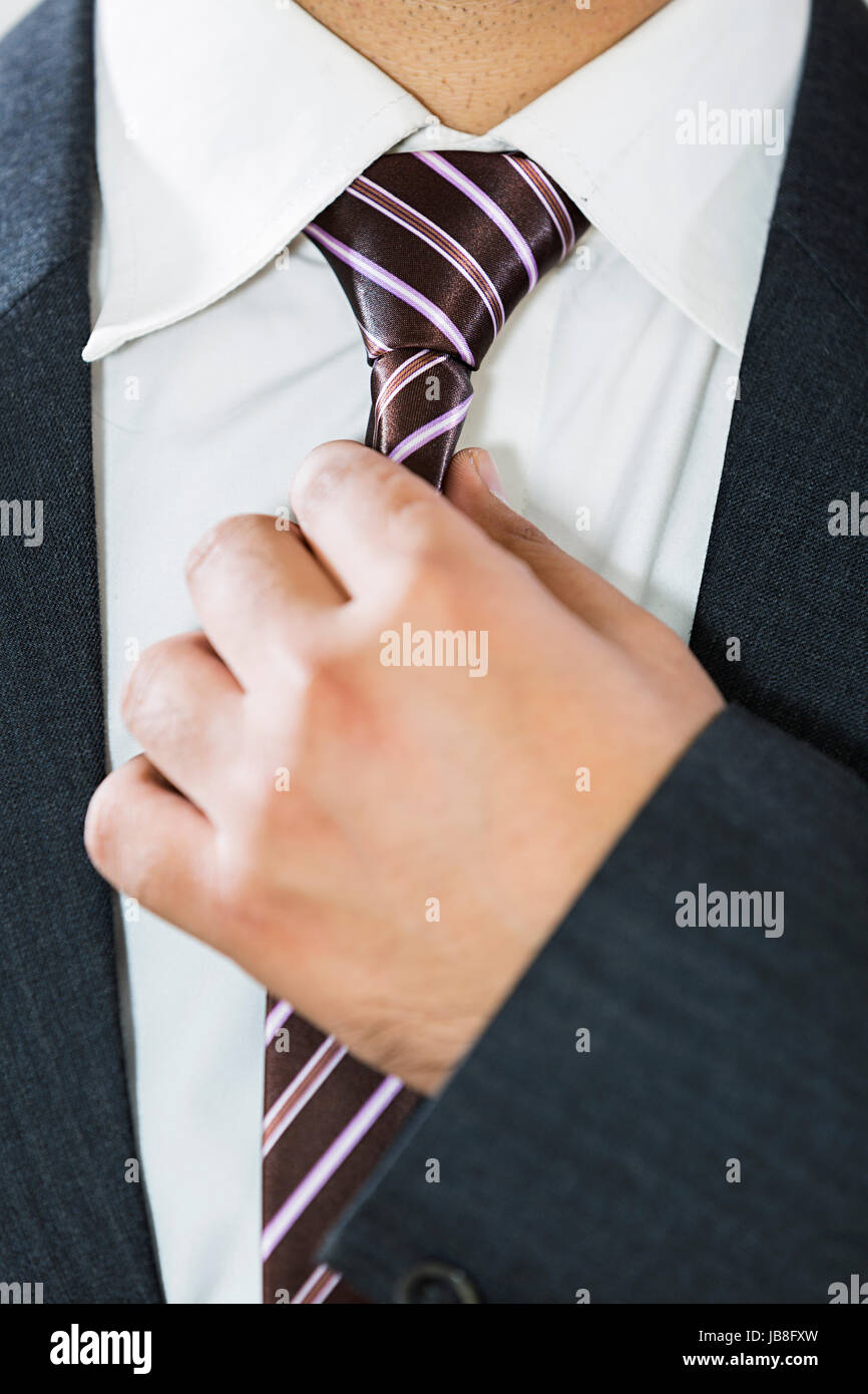 one Businessman Adjusting Tie Midsection Formal Clothing Stock Photo