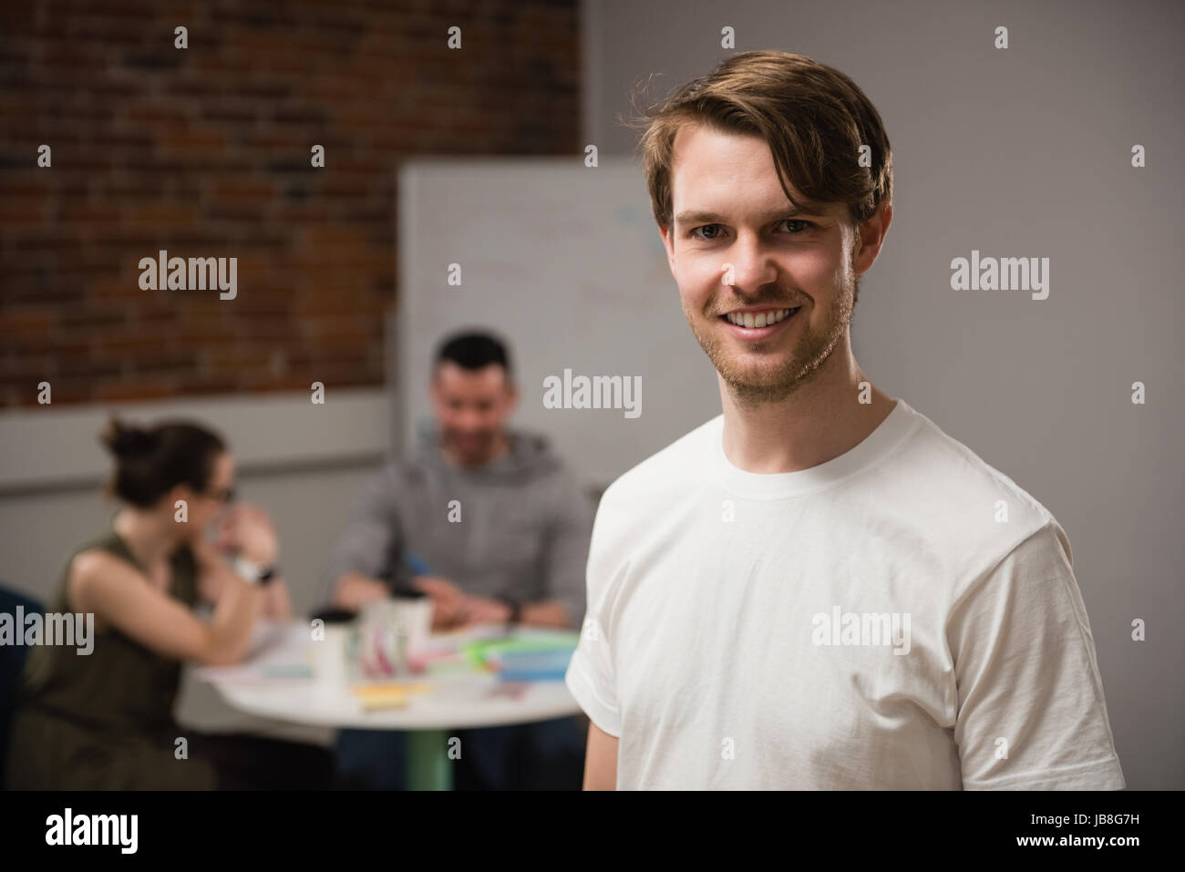 Portrait of smiling executive in office Stock Photo - Alamy