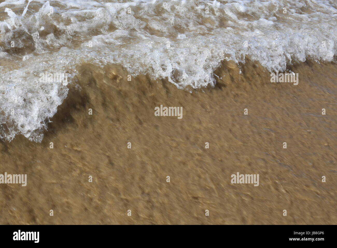 Close up of breaking wave lapping the shore Stock Photo