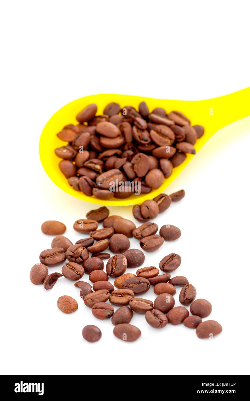 coffee beans in a plstic spoon on white background Stock Photo - Alamy