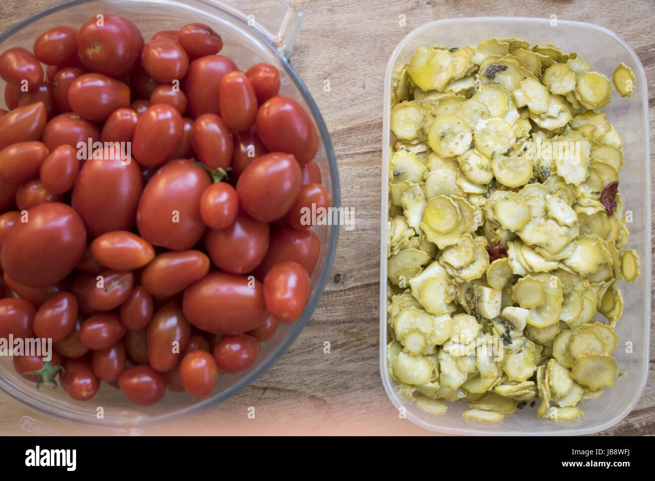 top view of zucchini in oil and fresh cherry tomatoes Stock Photo