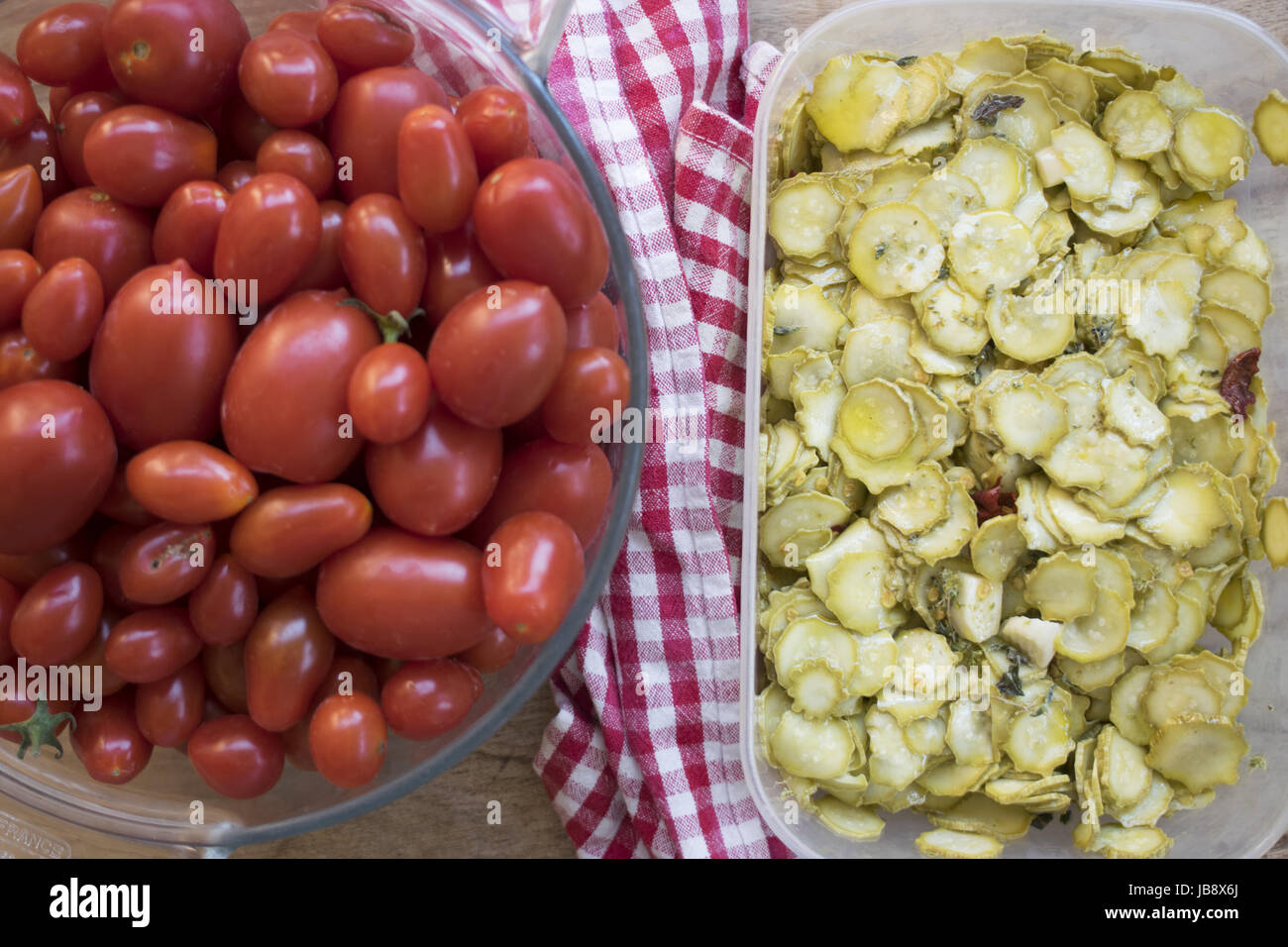 top view of zucchini in oil and fresh cherry tomatoes Stock Photo