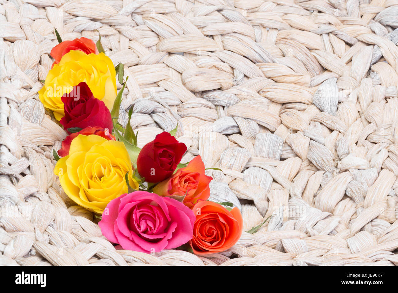 colorful roses in basket Stock Photo