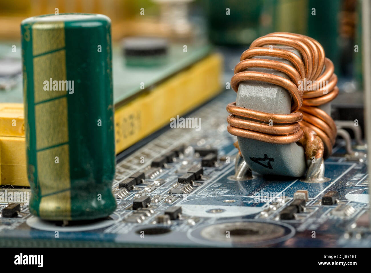 computer motherboard, detail of capacitor with shallow focus Stock