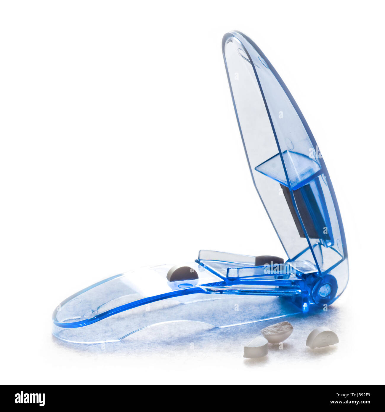 Daily medication cutting tablets in half with pillcutter Stock Photo