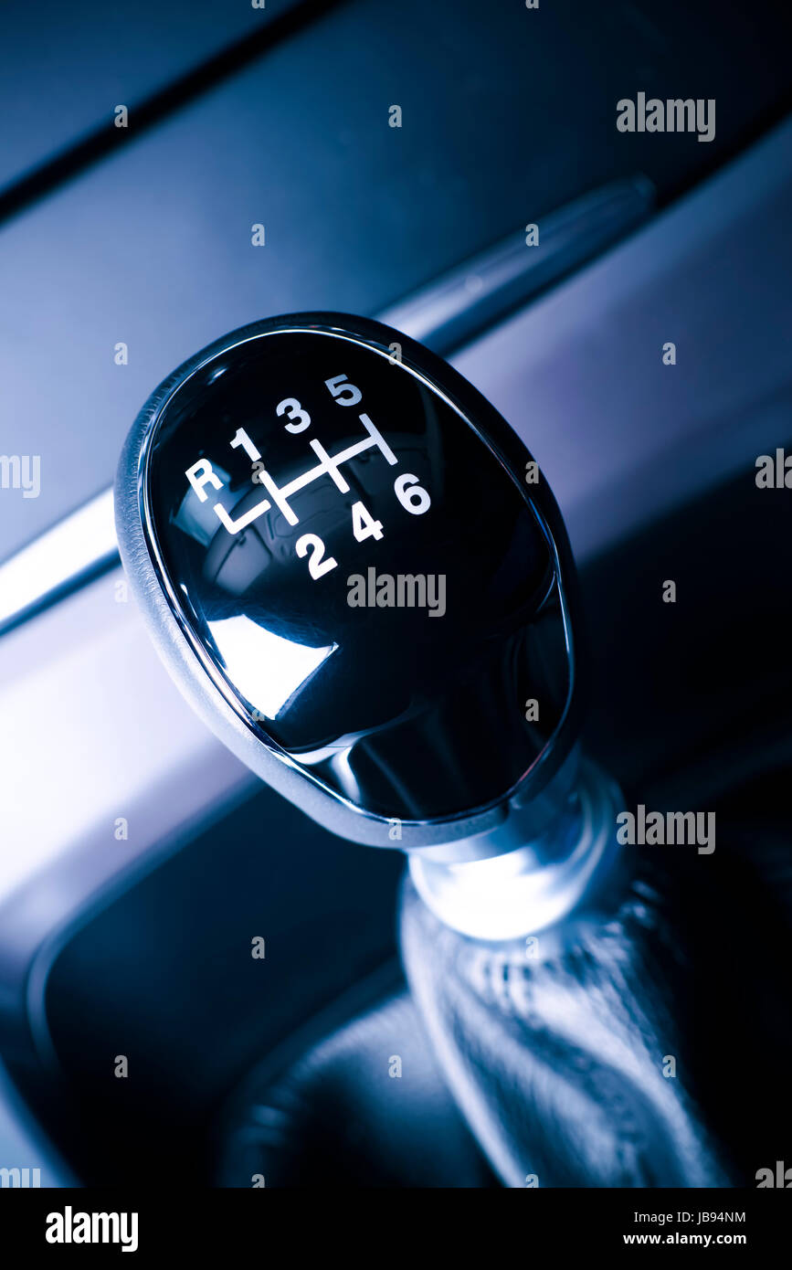 Interior of car, vehicle with visible lever of manual  transmission, with metal, chrome elements. Stock Photo
