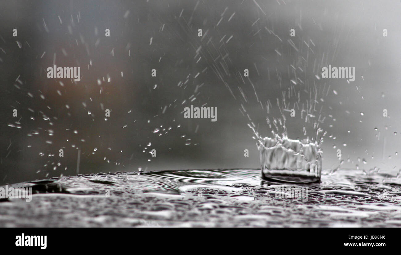 image of a raindrops falling on a table surface Stock Photo - Alamy
