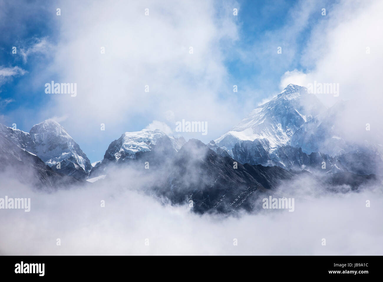 Mount Everest revelaed throught the clouds.  Sagarmatha National Park in the Himalayas of Nepal. Stock Photo