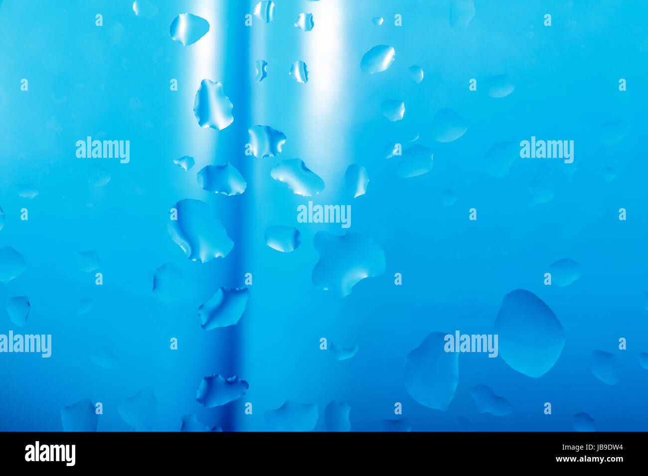 blue abstract background with water drops on glass with ribbon in ...