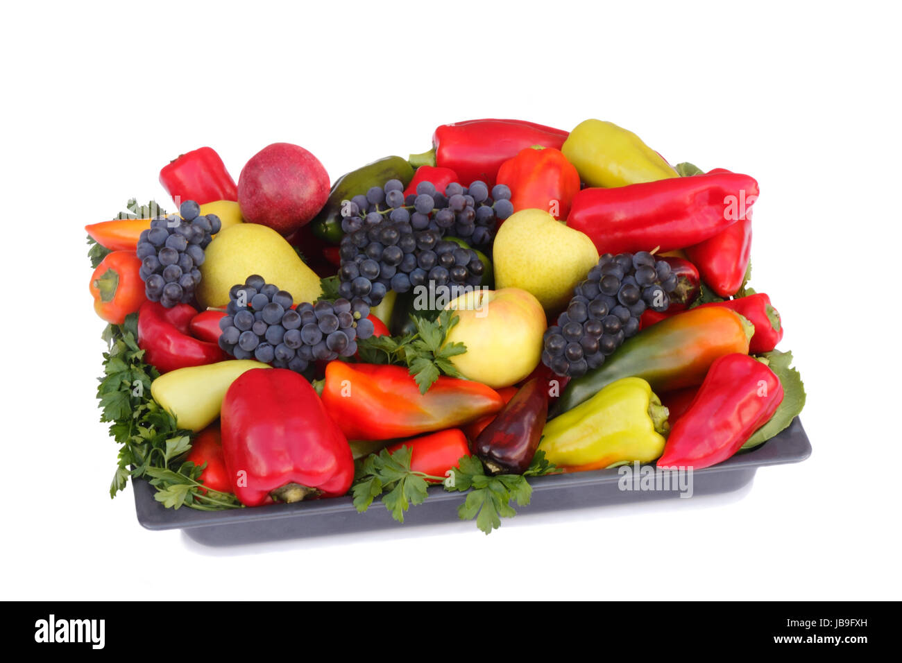 Ripe pears , apples , grapes and pepper on a platter. Presented on a white background. Stock Photo