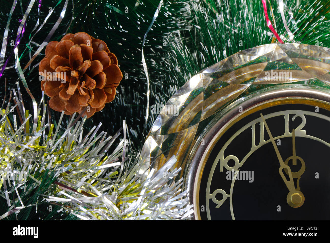 Beautiful watch around the Christmas tree show that before the arrival of the New year is five minutes. Stock Photo