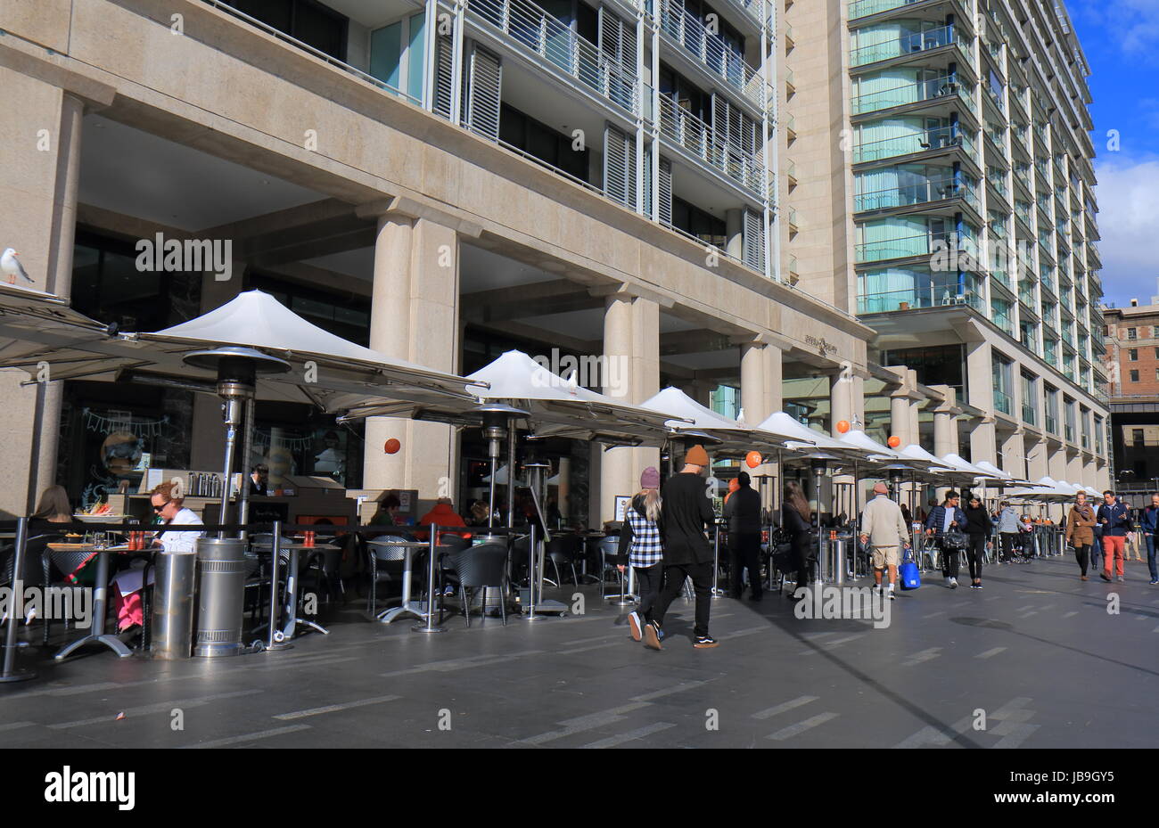 People dine at waterfront restaurant in Circular Quay Sydney Australia. Stock Photo