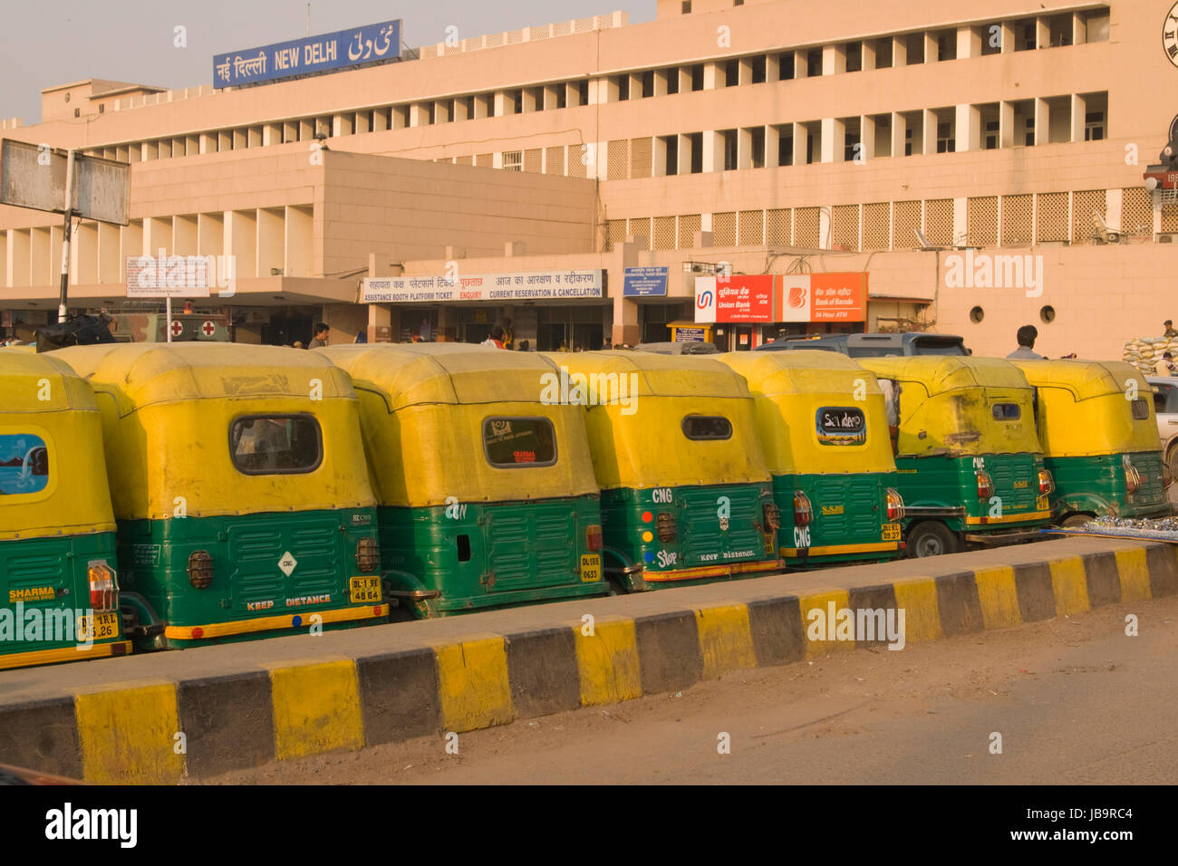 Row of yellow auto rickshaws outside New Delhi railway station in Delhi, India. Stock Photo
