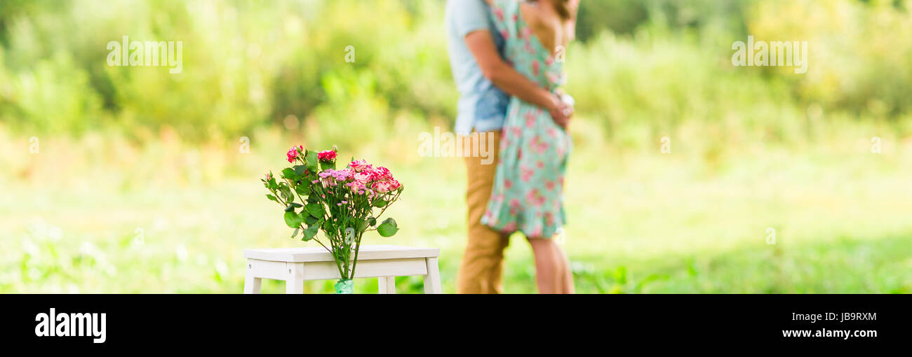 Happy Romantic couple hugging. Focus on flowers. selective focuse Stock Photo