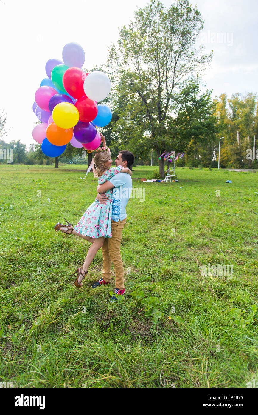 Young couple having weekend and walking with balloons on nature Stock ...